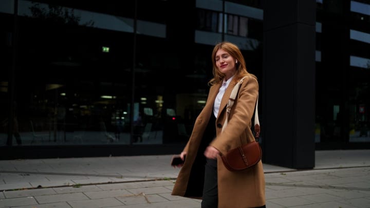 Confident Businesswoman Strolling Through Vienna's Modern Streets