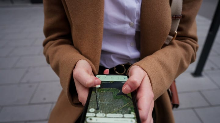 Businesswoman Navigates Vienna Streets With Smartphone Guidance