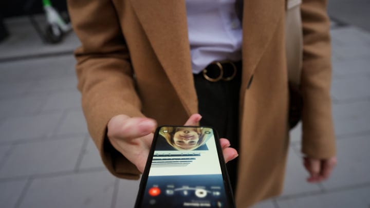 Businesswoman Shares Her Screen In A Bustling Vienna Cafe