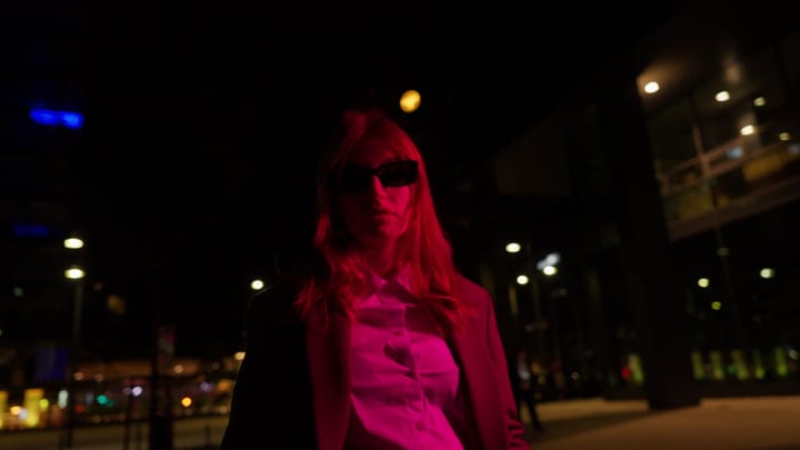 Chic Businesswoman Strolling Through Vienna's Night Lights