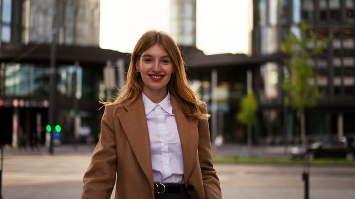 Confident Young Woman Strolling Through Vibrant Vienna Streets