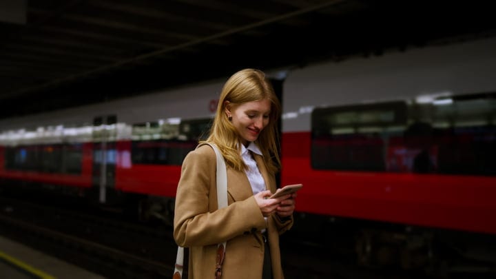 Businesswoman Engaged On Her Phone At Vienna Train Station