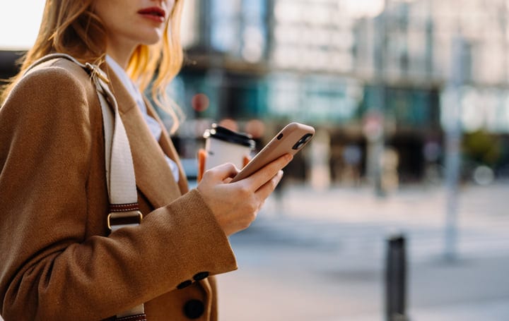 Morning Routine: Businesswoman Checks Phone at Vienna Cafe