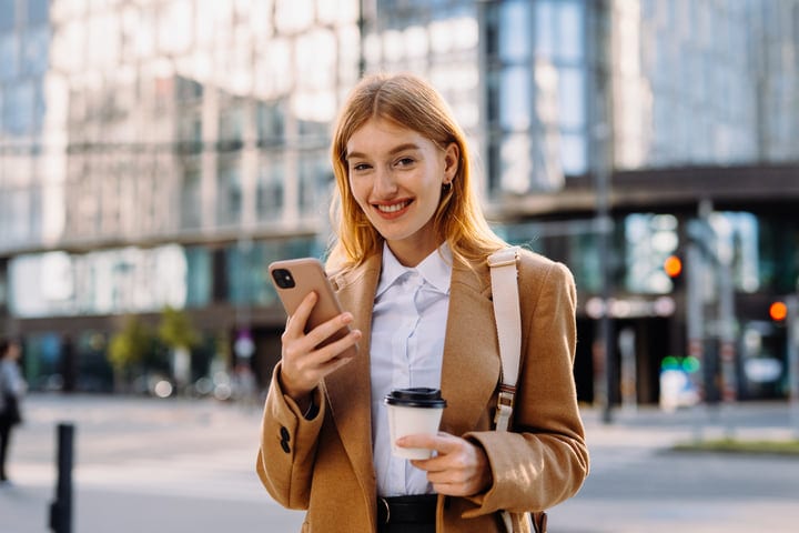 Modern Businesswoman Smiling With Coffee In Vienna’s Urbanscape