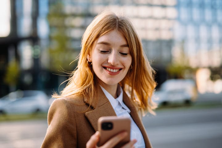 Businesswoman Enjoys Autumn Sunshine In Vienna With Her Phone