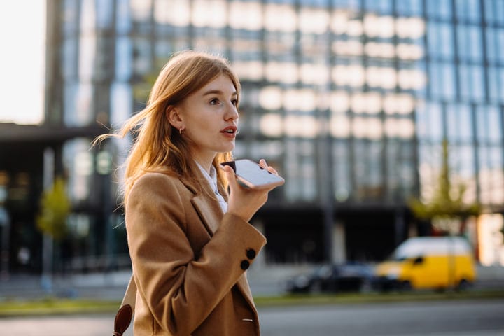 Confident Businesswoman Dictates Notes In Vienna's Bustling Streets