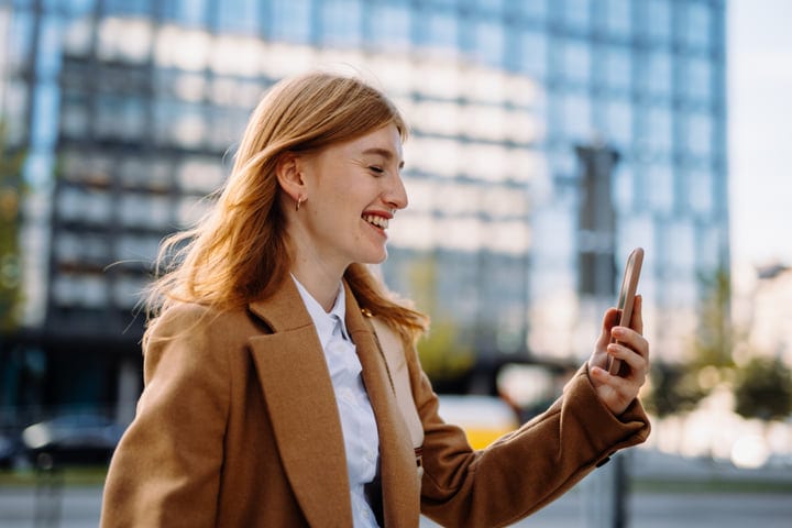 Businesswoman Enjoys A Digital Moment In Vienna's Autumn Light