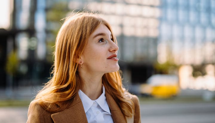 Businesswoman Gazes Skyward In Autumn Vienna Streets