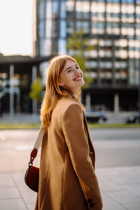 Sunlit Smile As Businesswoman Strolls Through Vienna Streets