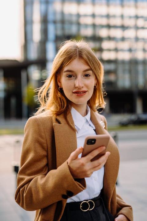 Young Professional Engages With Her Smartphone In Vienna