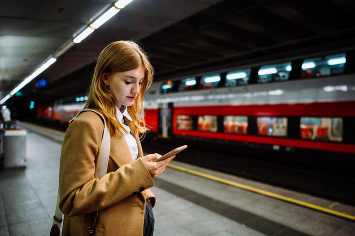 Young Professional Engages with Technology in Urban Metro