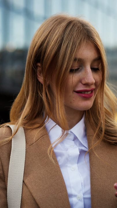 Businesswoman Embraces Autumn Stroll in Vienna Cafe