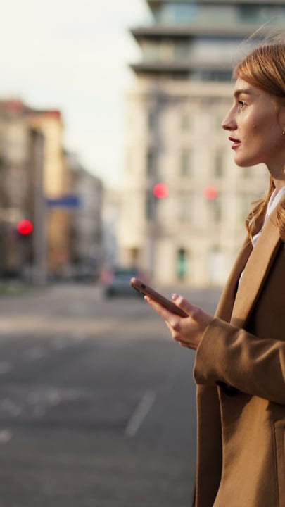 Contemplative Moment With Smartphone In Vienna's Morning Light