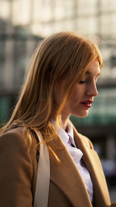 Businesswoman In Thoughtful Moment On Vienna Street