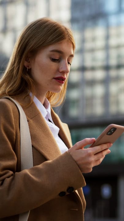 Morning Reflections: Businesswoman Engages with Her Smartphone