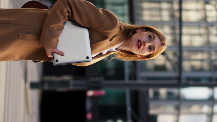 Businesswoman Embraces Urban Elegance With Laptop In Hand