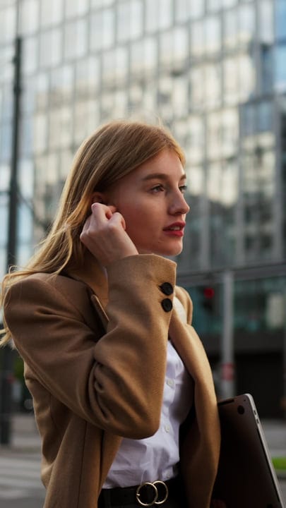 A Businesswoman Walks Confidently Through Vienna's Streets