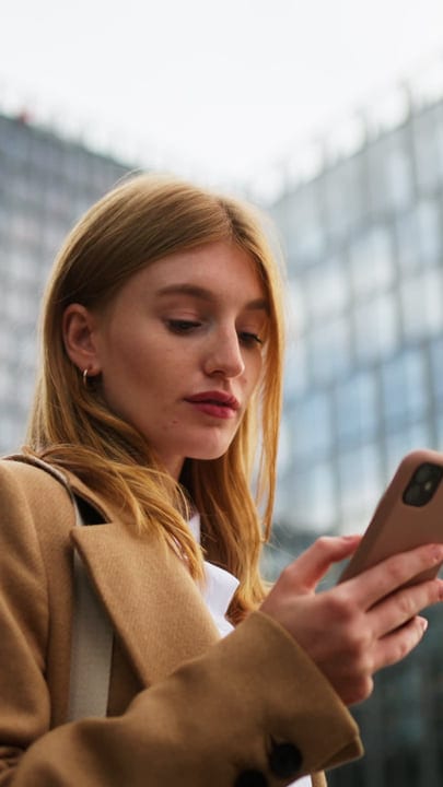 Focused Businesswoman Engaging with Her Phone in Vienna