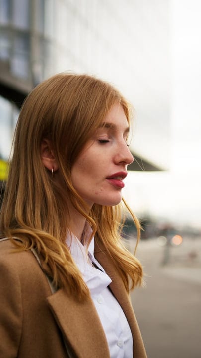 Contemplative Walk: Businesswoman Embracing Vienna's Autumn Breeze