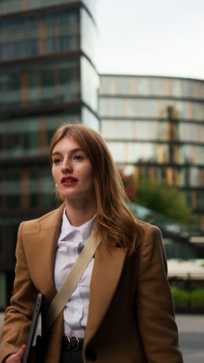 Confident Businesswoman Strolling Through Vienna's Modern Streets