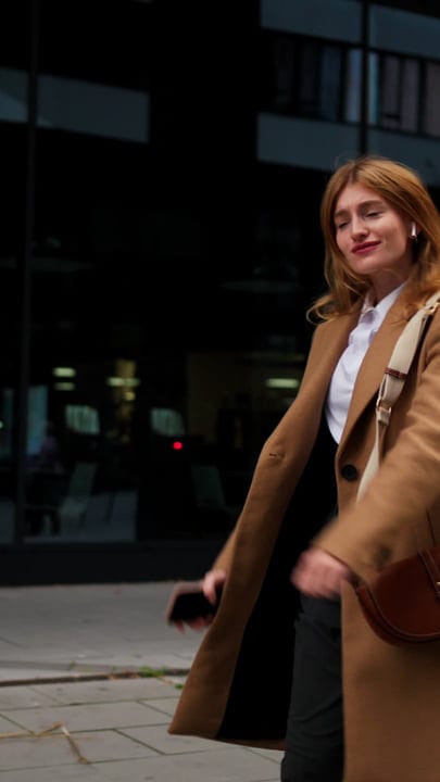 Confident Businesswoman Strides Through Vienna's Urban Landscape