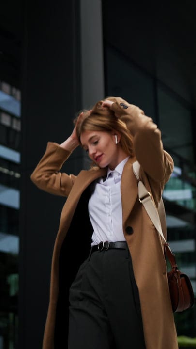 Confident Businesswoman Adjusts Her Hair In Vienna's Breeze