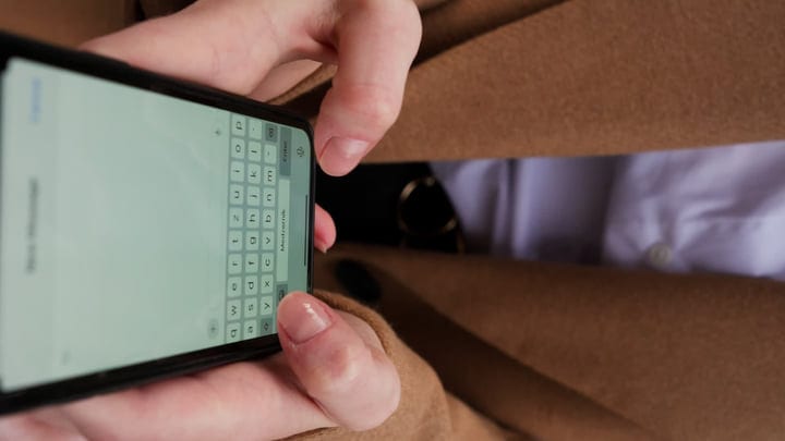 Focused Businesswoman Typing on Smartphone in Vienna Cafe