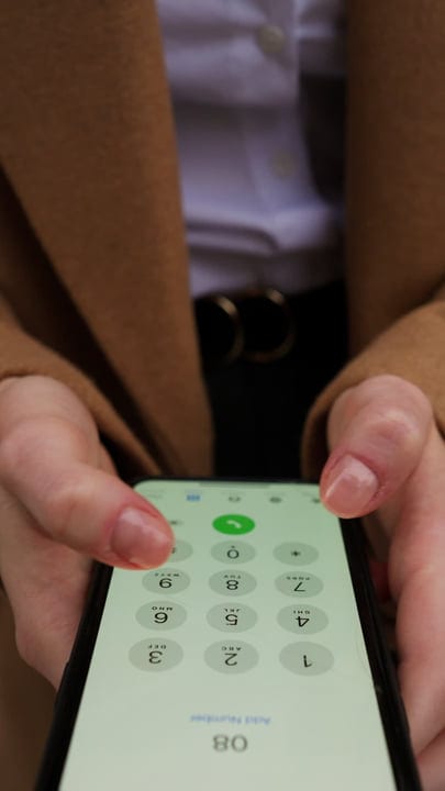 A Businesswoman Dialing Numbers In Vienna Cafe Ambience
