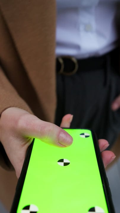 Businesswoman Navigates Her Smartphone In A Vienna Cafe