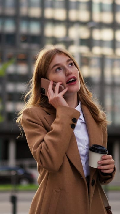 Engaged Businesswoman Chats in Vienna's Bustling Streets