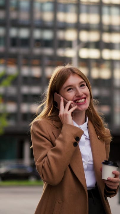 Businesswoman Laughs on a Call in Vienna's Autumn