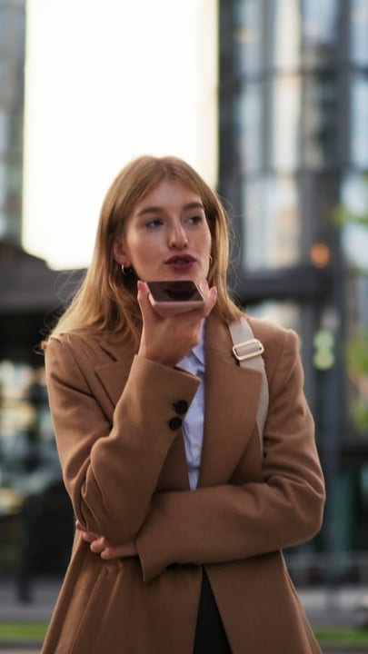 Businesswoman Communicating on Smartphone in Vienna's Autumn Glow