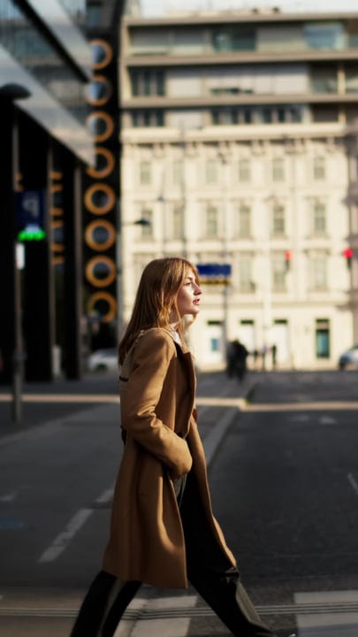 Confident Businesswoman Striding Through Vienna's Streets