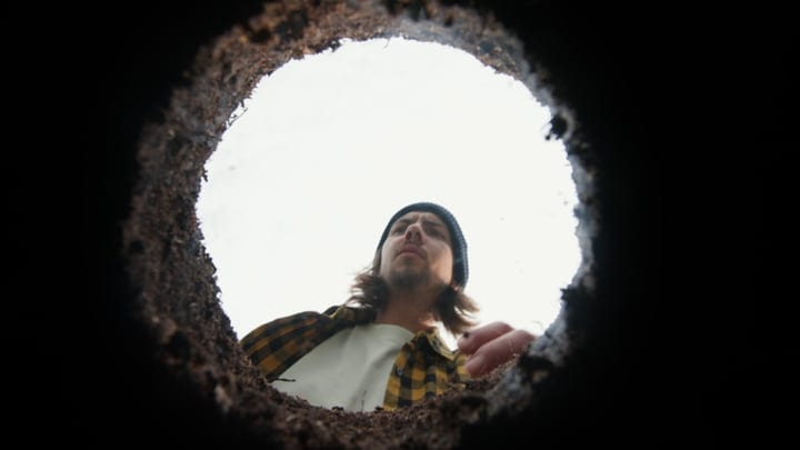 Looking Up From The Earth At A Gardener's Focused Gaze