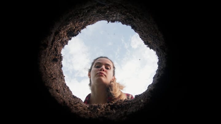 Curious Gardener Peering Into Freshly Dug Earth