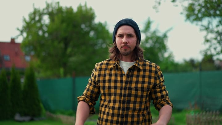 Young Gardener Embraces Autumn in a Checkered Shirt