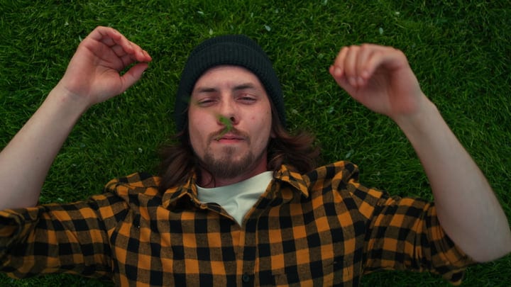 Relaxed Gardener Lying on Freshly Mowed Lawn