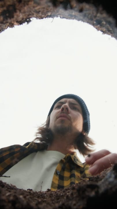 Young Gardener Looks Up From Soil Perspective