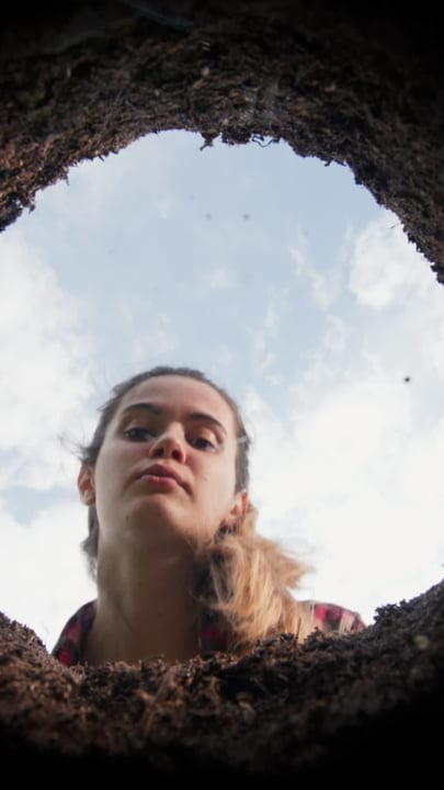 Curious Gardener Peers Into Freshly Dug Earth Below