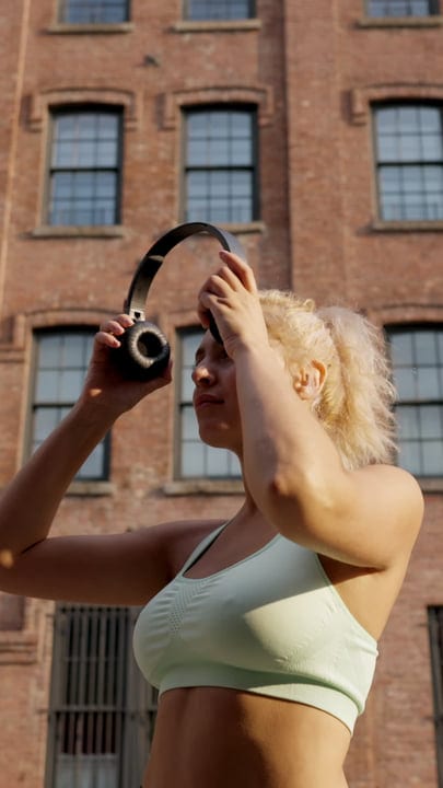 Young Athlete Prepares for Outdoor Workout in Urban Setting