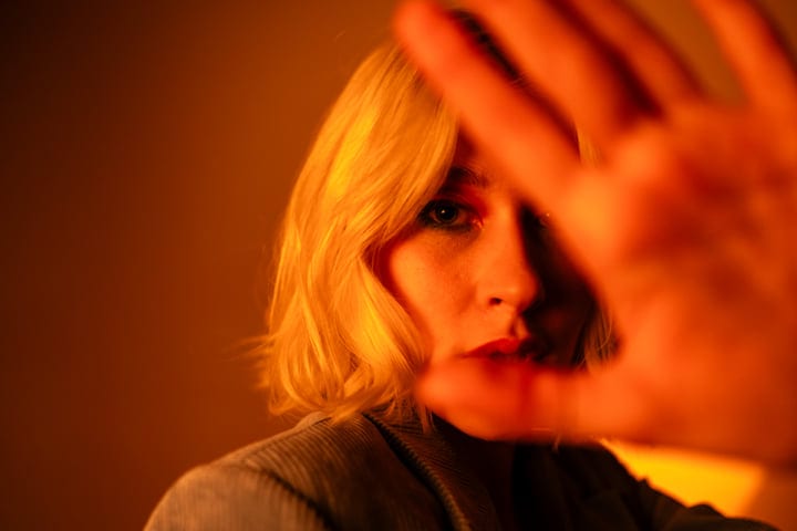 Gen Z Gaze Through Soft Amber Light In Studio Setting