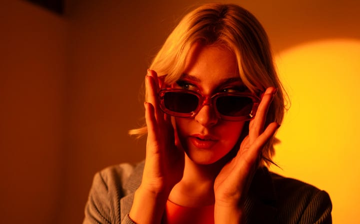 Gen Z Confidence Shines Through Sunglasses In Studio Glow