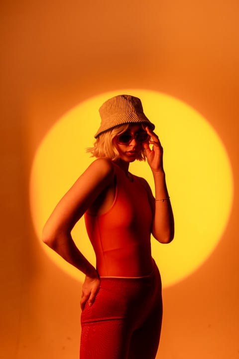 Gen Z Style Icon Poses Against Vibrant Backdrop