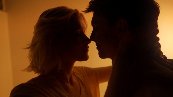 Silhouetted Embrace Against a Warm Studio Backdrop