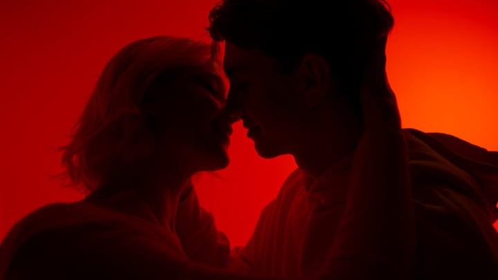 Intimate Silhouettes Against a Vibrant Red Backdrop