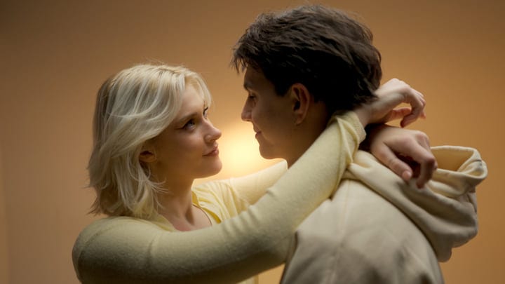 A Tender Moment Between Young Adults In Warm Tones
