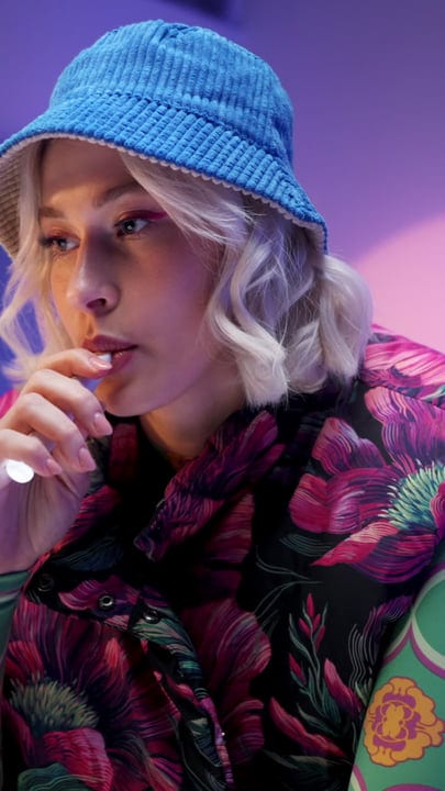 Contemplative Gen Z in Blue Hat and Floral Shirt