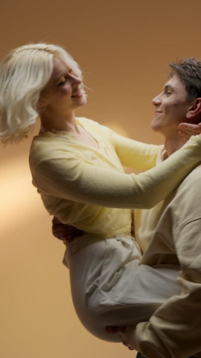 Young Couple Embracing in Warm Studio Glow