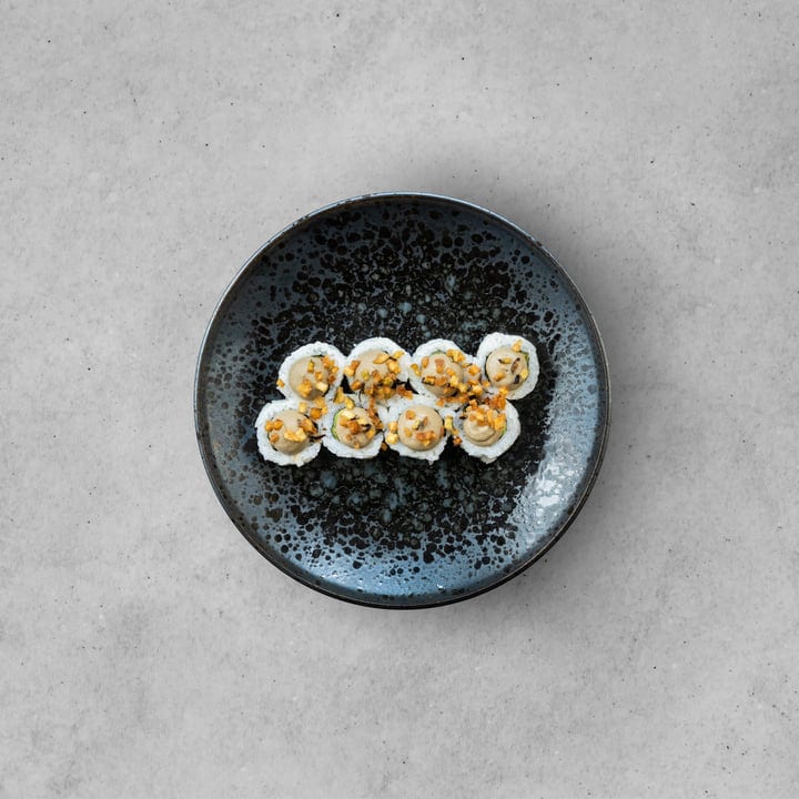 Elegant Sushi Rolls Artfully Plated On Ceramic Dish