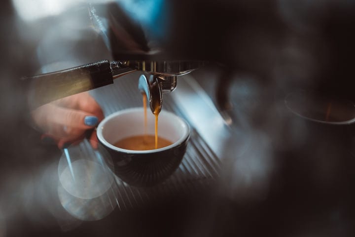 Rich Espresso Flowing Into a Ceramic Mug